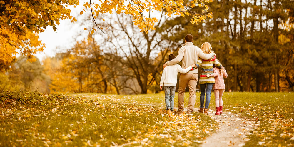 a happy family going for a Autumn walk
